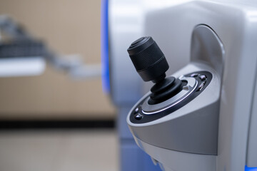 A close-up view of the ergonomic, high-precision joystick control interface used by the surgeon to manipulate and position the ZEISS Femtosecond Laser System during refractive eye surgery (SMI