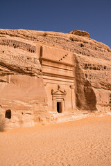 Portal of Nabataean rock cut tombs carved into the mountain face at the Hegra site in Saudi Arabia