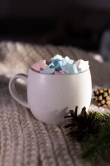 closeup mug filled with pastel marshmallows and soft ambient light. intimate product-style shot highlights