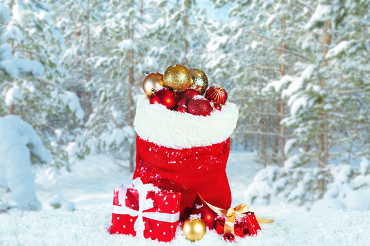 Santa's red sack full of presents. Winter snowy landscape.