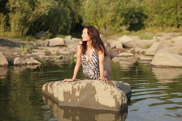 Beautiful bikini model splashing water	
