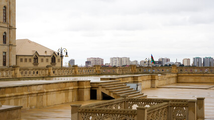 Wide view of Heydar Aliyev Mosque’s stone terrace overlooking urban Binəqədi skyline in Baku, Azerbaijan