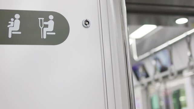 Priority seating symbols clearly displayed inside subway train. Dedicated space ensures comfort, safety vulnerable passengers. Concept accessible subway. Modern metro diverse mobility needs.