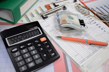 Business and accounting supplies arranged in a composition on an office desk.