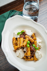Delicious rigatoni with rich sauce and fresh basil, served in a chic restaurant