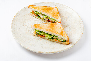 Crisp lettuce, juicy tomato, and creamy spread fill this toasted sandwich, perfect for lunch