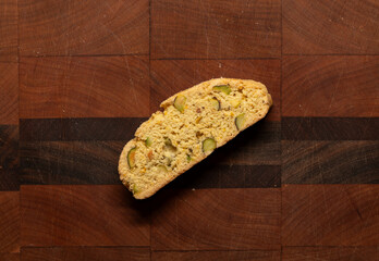 Single isolated biscotti on a wood cutting board, freshly baked