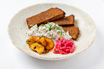 Savory rye bread slices pair with rich chicken salad, fresh herbs, and pickled onions