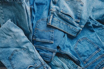 A Creative Arrangement of Various Denim Jeans Showcasing Different Textures, Styles, and Shades of Blue in a Stylish Composition