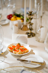 A cozy atmosphere with a lovely table, tasty appetizers, and warm candlelight