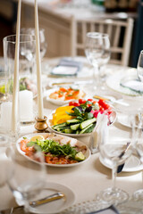 A stunning table showcases fresh salads and vibrant dishes, perfect for a festive gathering