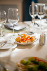 Tasty appetizers on an elegant table, complemented by fine glassware and decor