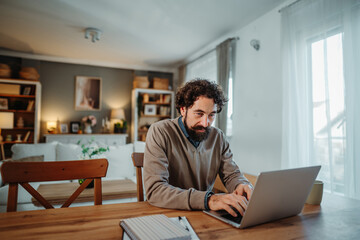 Man working remotely on laptop from home office