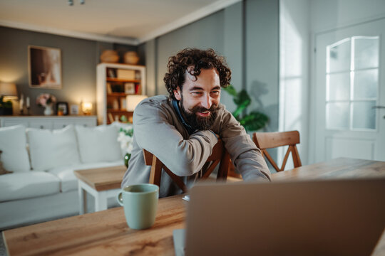 Man smiling during video call from home working