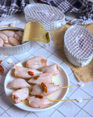 Gourmet canned squid served with unopened cans and olives on a tile surface. High quality Spanish seafood tapas ready to eat, perfect for food industry concepts