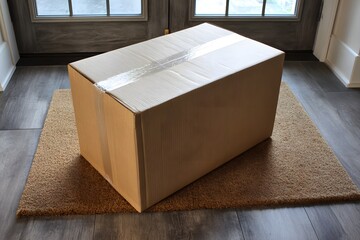 Standard medium moving box on a doormat