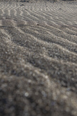Abstract patterns formed by water on Saksun’s black-sand beach.