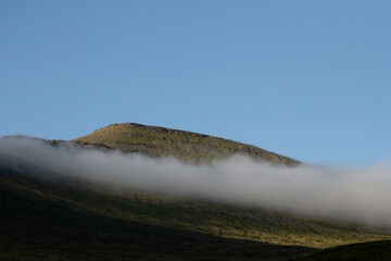 Low cloud “hats” crown the mountain tops—one of the whimsical sights awaiting travelers on Faroe Islands hiking routes.