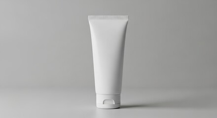 Simple white tube of hand cream with secure cap resting on smooth plain presentation surface display