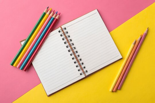 Colorful Pencils and a Blank Notebook on a Vibrant Background for Creative Ideas