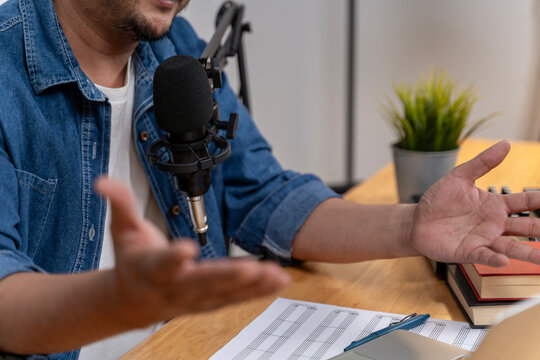 A young man records a podcast in a professional studio, representing modern online careers and digital content creation.