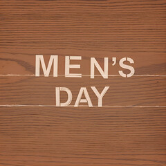Men's Day writing with a clean wooden background and full varnish