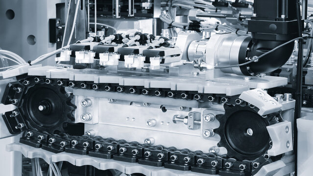 Conveyor for the production and packaging of food products in plastic packaging, industrial concept background - Powered by Adobe