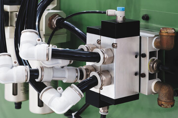 Part of an industrial machine with wires leading to a junction box or conveyor control unit, industrial concept background.