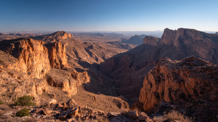 Fototapeta premium Breathtaking panoramic view of a vast rocky mountain landscape under clear sky