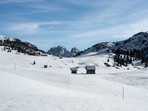 Pratopiazza, Braies, Dolomiti: baite in legno su neve con abeti e vette; paesaggio alpino invernale per uso editoriale turistico ambientale e promozionale, contenuti natura e viaggi, architettura mont