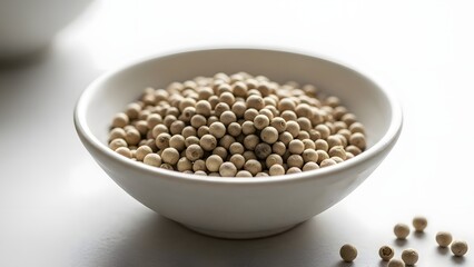 White peppercorns in ceramic bowl macro kitchen spice ingredient