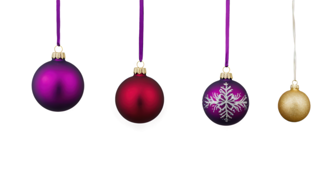 Colorful Christmas ornaments in various designs and sizes hanging on purple ribbons ready for holiday decoration