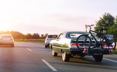 Fototapeta premium Classic vehicle with bicycle loaded for vacation