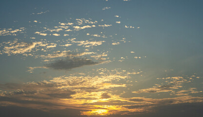 Bright sunrise sky background with clouds.