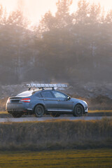 Naklejka premium Car with cargo box driving in nature landscape