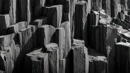 Jagged basalt columns rising in vertical formation captured with perfect exposure and sharp detail Shadows fall naturally emphasizing