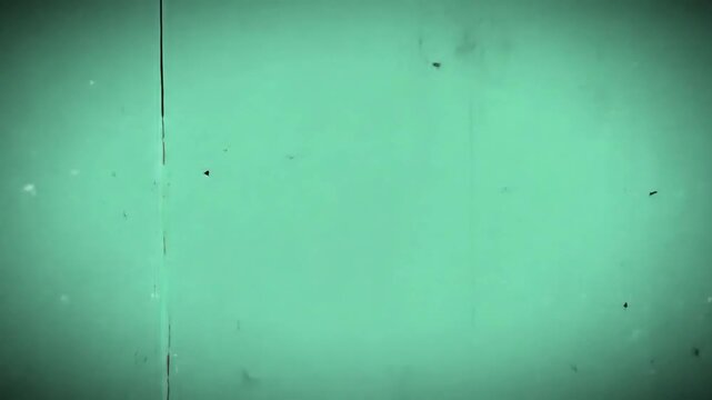 Old filmstrip frame with damaged edges and mint green background.