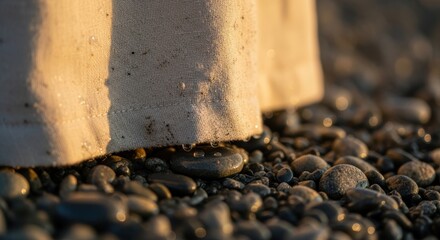 White fabric on wet stones at sunset beach close-up