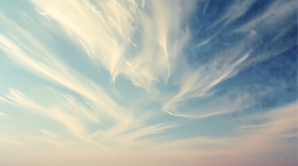 Dreamy wispy clouds drifting across a serene sky, soft ethereal sunrise