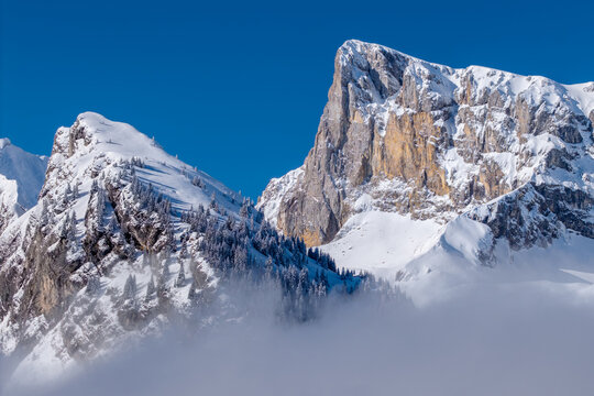 Aerial view of Pic de Bure and Crete d’Ane, with snow-covered cliffs of the Devoluy Massif. Winter alpine landscape in the Hautes-Alpes, French Alps, France