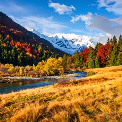 Fototapeta premium Scenic view of a river winding through autumn forest with snowy mountains