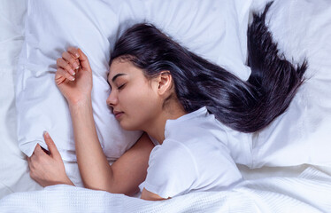 young woman sleeping on bed