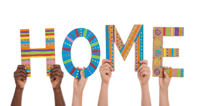 Colorful multiracial child hands holding letters that form the word home in a cheerful display of creativity at a friendly gathering