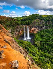 Scenic view of cascading water with surrounding lush, vibrant greenery