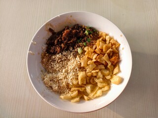 Delicious Traditional Indonesian Beef Rendang with Rice and Acar on White Plate