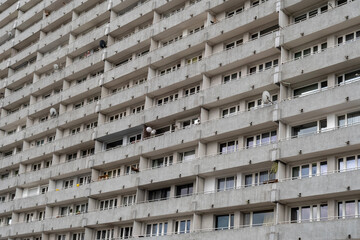 Concrete apartment block facade with repetitive balconies &mdash; urban residential architecture