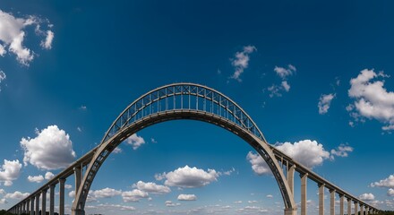 Obraz premium A high-angle view of a modern bridge under a blue sky dotted with puffy white clouds