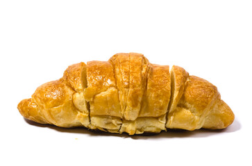 A golden brown butter croissant isolated on a white background. The croissant is ready to be served and has been cut into several pieces.