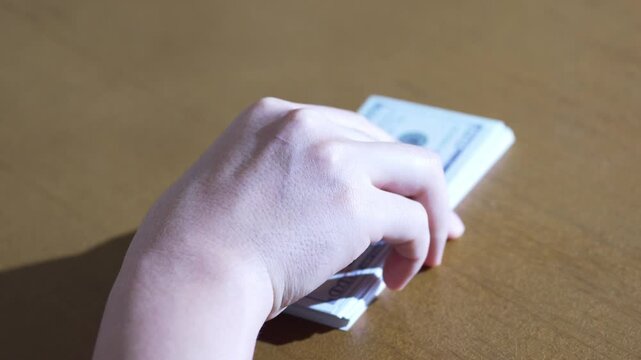 Dropping a Stack of USD Bills Flat on Surface