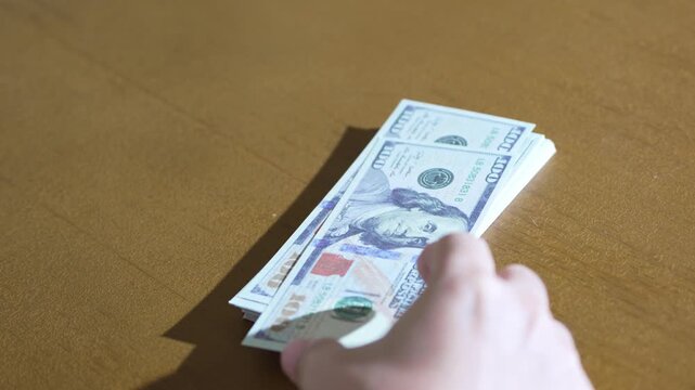 Counting US Dollar Bills on Table One by One